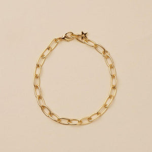 Gold Chain Bracelet on Tan Background