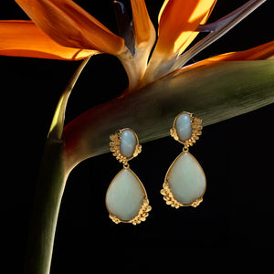 Stone and Gold Double Drop Earrings Staged on Birds of Paradise Flower with Black Background