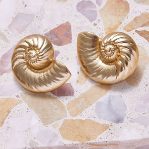 Gold Shell Stud Earrings Styled on Tile