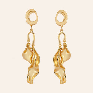 Gold Wavy Double Drop Earrings on Tan Background