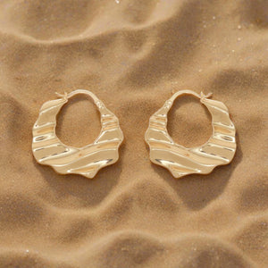 Wavy Gold Hoop Earrings on Flat White Background
