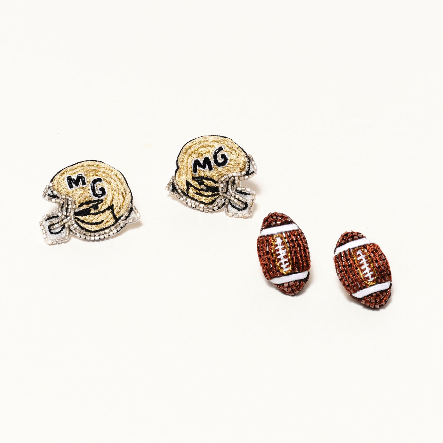 Gold and Black Beaded Football Helmet Stud Earrings on Tan Background