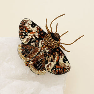 Bronze and Gold Beaded and Embroidered Moth Brooch on Tan Background