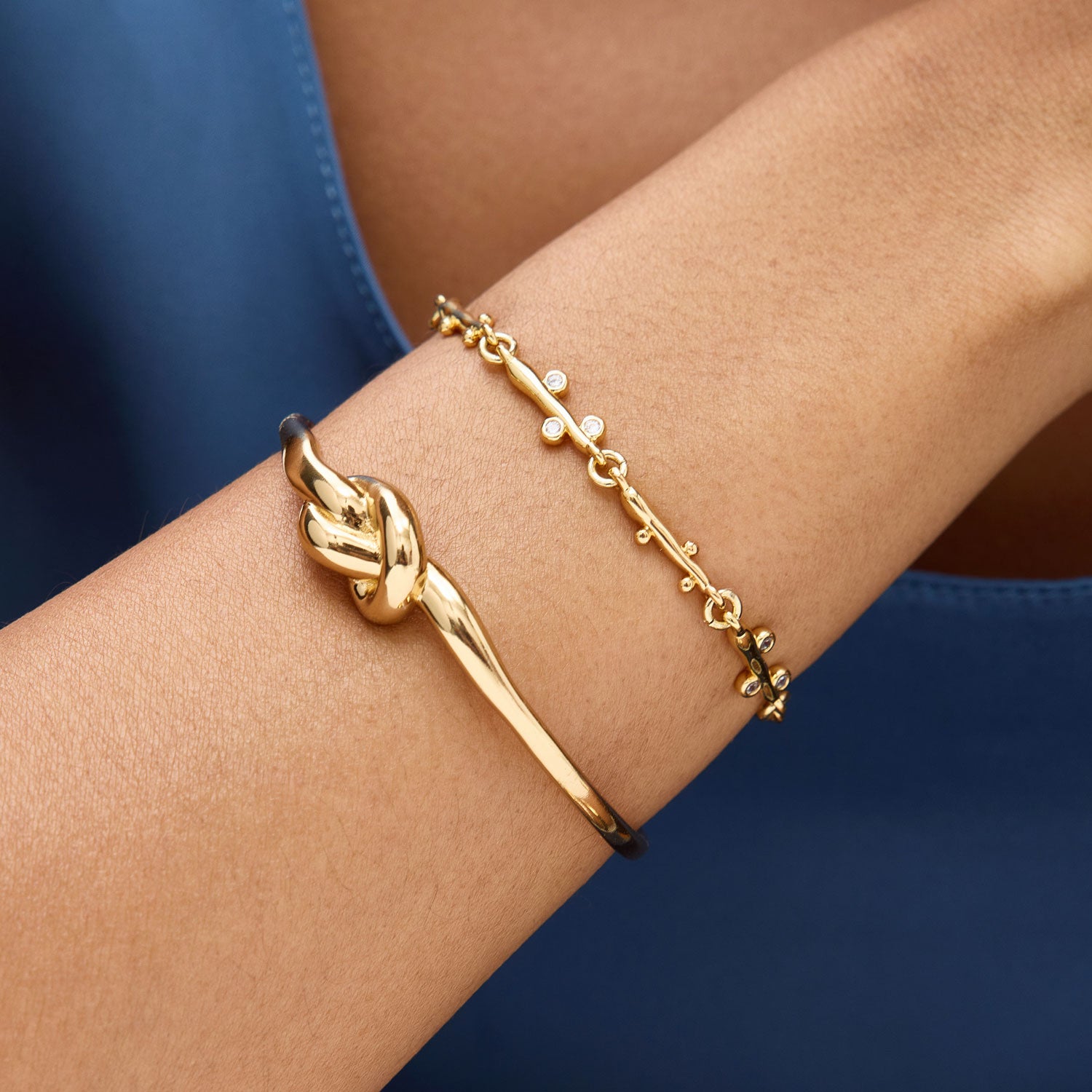 Gold and Crystal Chain Bracelet Styled on Model with Gold Knotted Cuff Bracelet