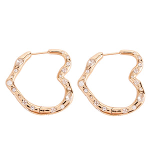 Gold and Crystal Heart Hoop Earrings on Flat White Background