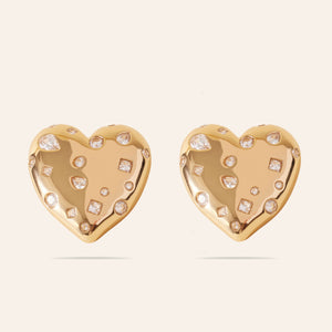 Gold and Crystal Heart Stud Earrings on Cream Background