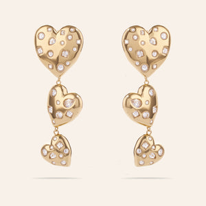 Crystal and Gold Triple Drop Heart Earrings on Cream Background