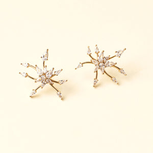 Crystal and Gold Star Studs on Tan Background