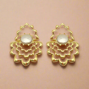 Gold and Pearl Drop Earrings on Tan Background