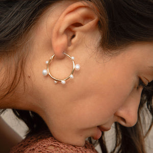 Gold and Multi-Sized White Pearl Hoop Earrings Styled on Model