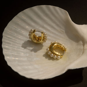Gold and Pearl Hoops Staged in White Shell with Black Background