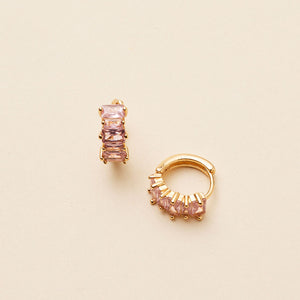 Pink Crystal Hoop Earrings Staged on Flat Cream Surface