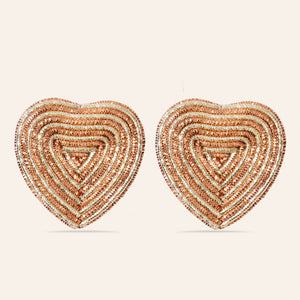 Metallic Gold and Rose Gold Embroidered Heart Stud Earrings on Cream Background