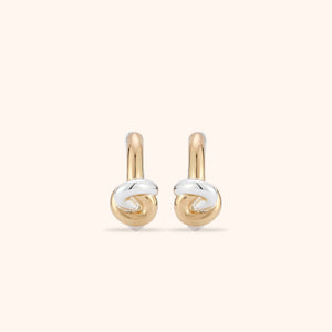 Gold and Silver Knotted Hoop Earrings on Tan Background