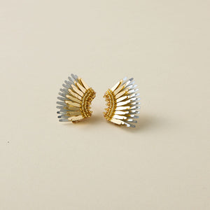 Gold and Silver Wing Stud Earrings on Tan Background