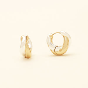 Gold and Silver Hoop Earrings On Cream Background