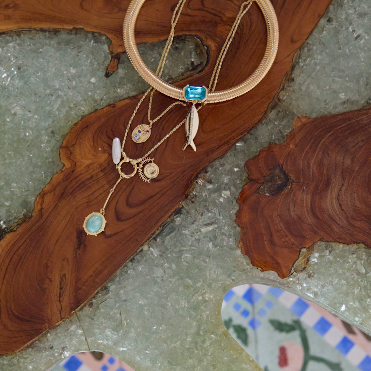 Gold necklaces with blue stones on a wooden surface