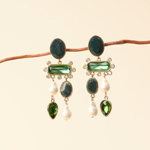 Green Stone, Crystal, and Freshwater Pearl Chandelier Drop Earrings Staged on Branch with Tan Background