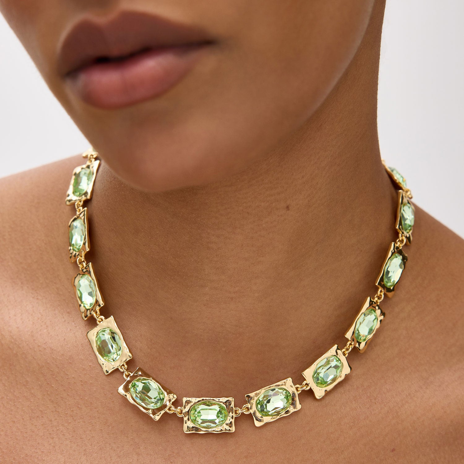 Gold Necklace With Green Gemstones Styled on Model