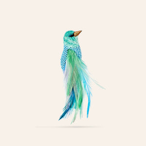 Blue and Green Beaded and Feather Bird Brooch on Cream Background