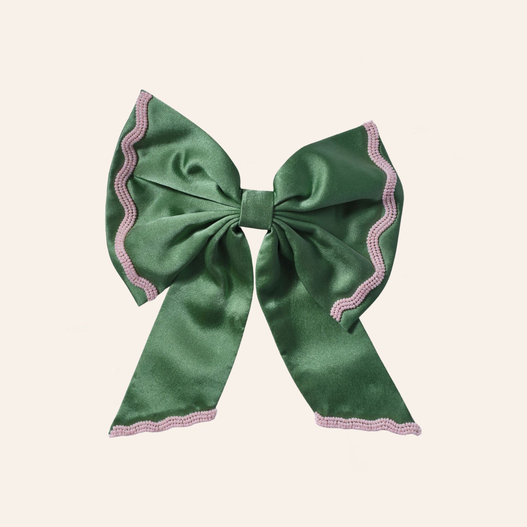 Green and Pink Bead Embroidered Hair Bow on Tan Background