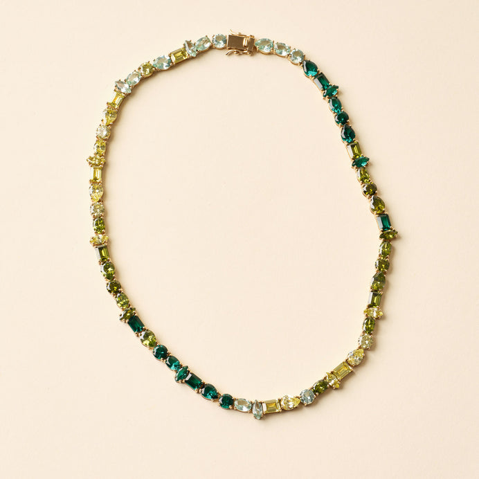 Green Multi Crystal Tennis Necklace On Tan Background