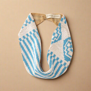 Blue and White Beaded Scarf Necklace on Cream Background