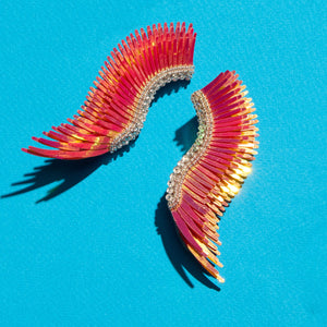 Coral Sequin Wing Earrings on Blue Background