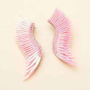 Pink Sequin Wing Earrings on Tan Background