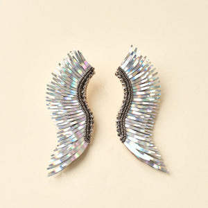 Iridescent Silver Wing Earrings on Tan Background