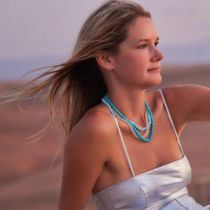 Strand Necklaces in Shades of Blue Styled on Maggie in Silver Outfit in the Desert