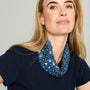 Blue scarf necklace featuring floral and beaded embellishments throughout on model looking straight