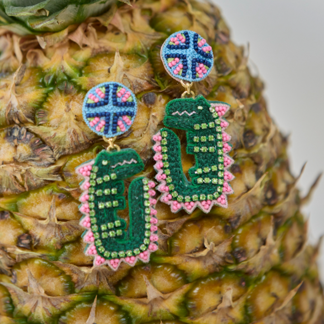 Pineapple with decorative earrings on a blurred background