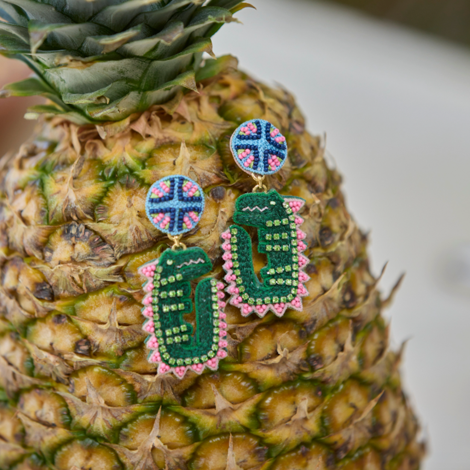 Pineapple with decorative earrings on a blurred background