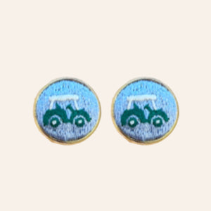 Blue golf cart embroidered cuff links on tan background