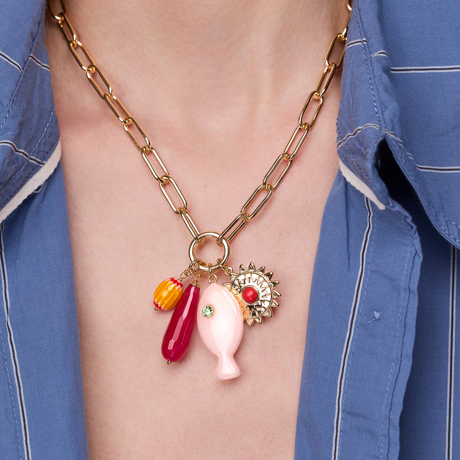 Gold Chain Necklace with colorful charms worn by a person in a blue shirt