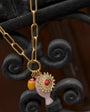 Necklace with a decorative pendant on an ornate metal background
