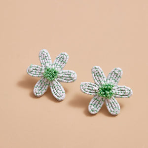 Green and White Flower Stud Earrings on Cream Background