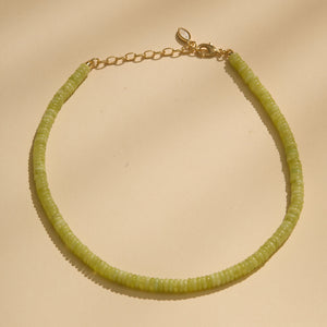 Lime Green Strand Necklace on Flat Cream Background