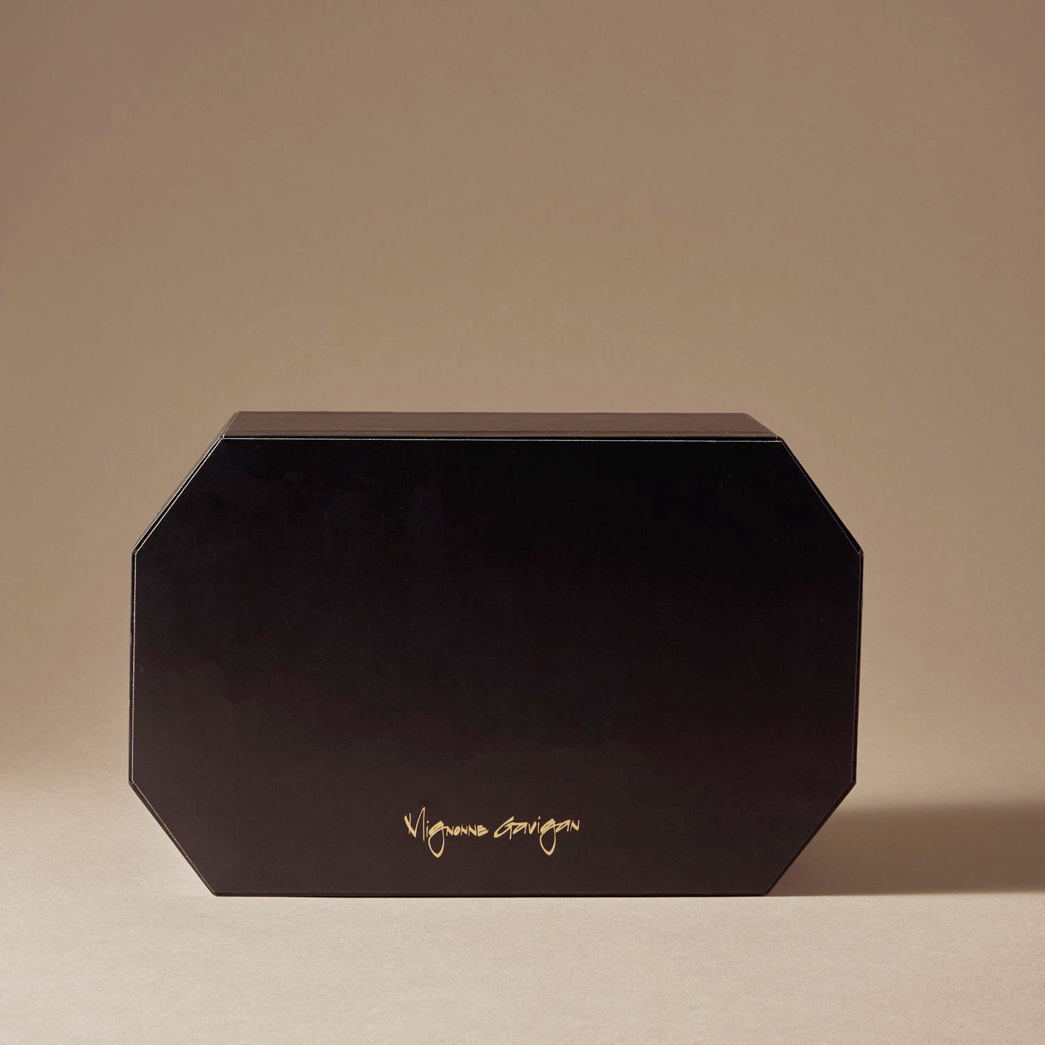 Black Advent Calendar with Gold Logo Staged with Tan Background