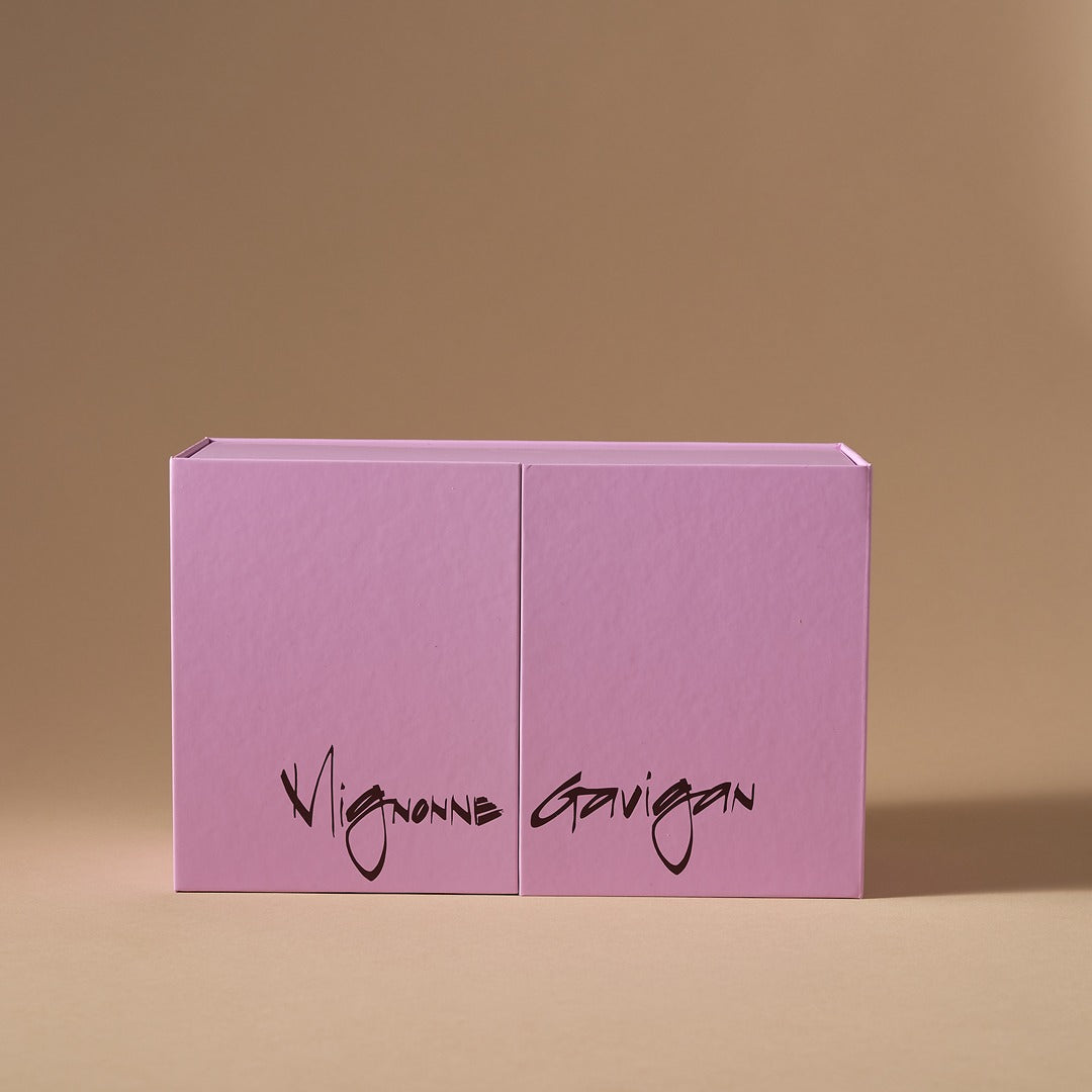 Lilac colored box with Mignonne Gavigan script on brown background