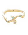 Gold bracelet with turquoise stones on a white background