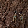 Cicada Inspired Black, Green and gold dangle earrings on tree bark