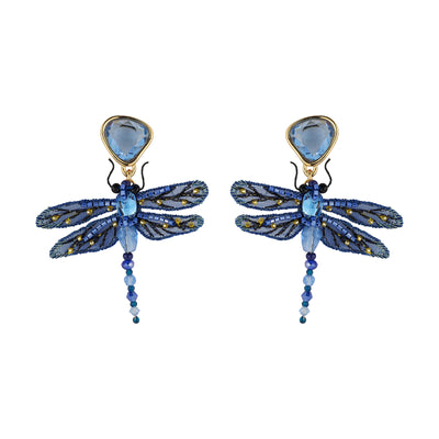 A pair of dragonfly drop earrings featuring blue and gold beaded wings, a light blue faceted gemstone top, and dangling blue beads, shown on a plain white background.