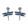 A pair of dragonfly drop earrings featuring blue and gold beaded wings, a light blue faceted gemstone top, and dangling blue beads, shown on a plain white background.