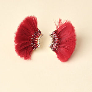 Red Feather and Crystal Wing Earrings on Tan Background