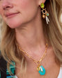 Model wearing colorful shell necklace and colorful earrings