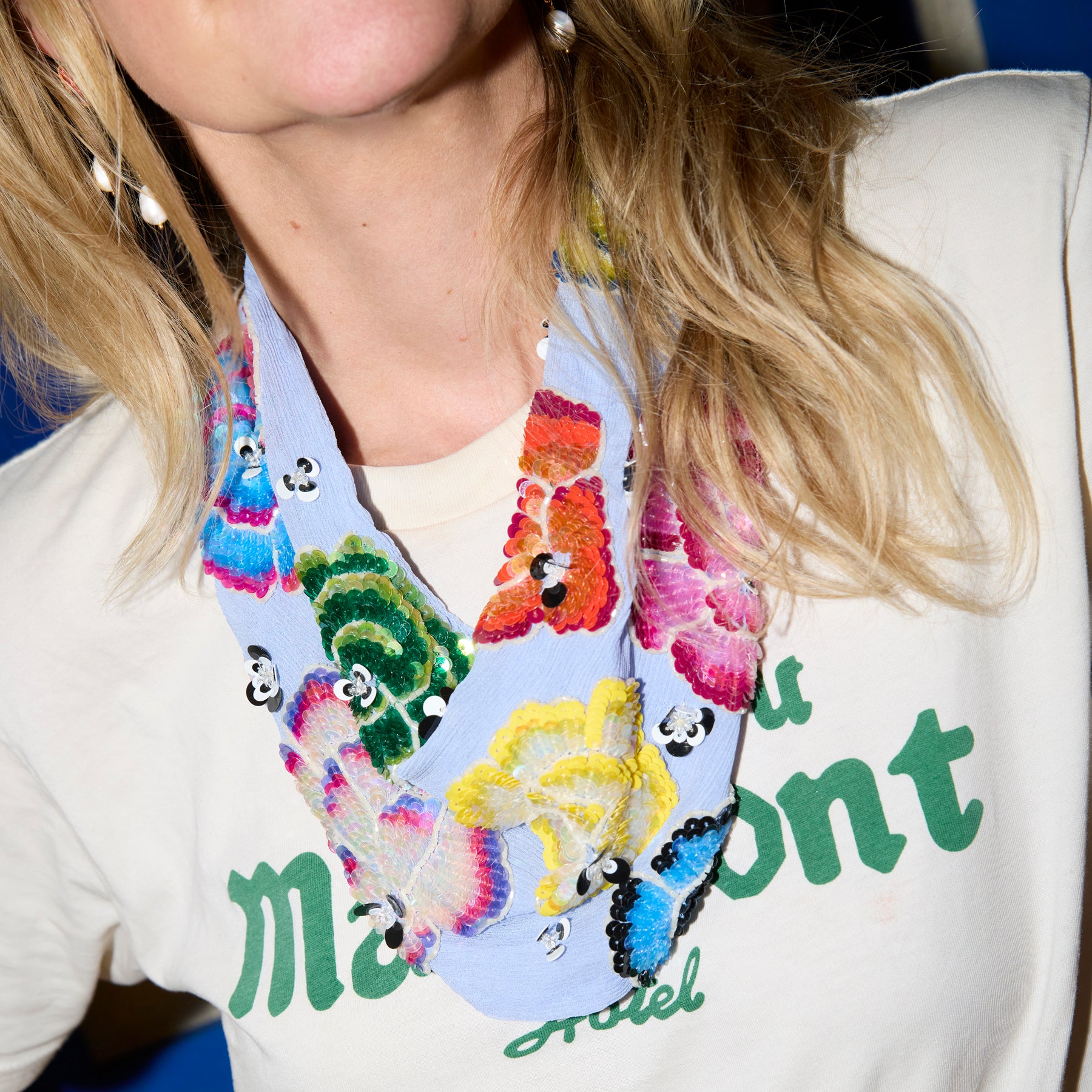 Model wearing white t shirt with colorul scarf necklace 