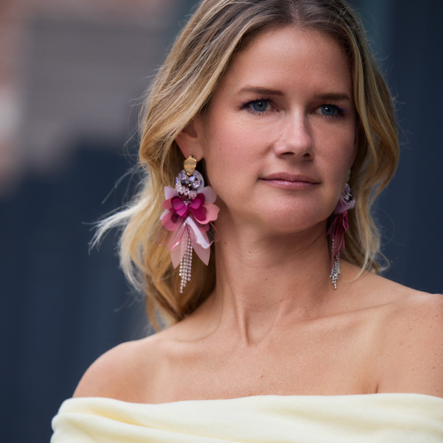 Maggie wearing yellow top and floral earrings