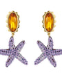 Starfish-shaped earrings with orange gemstones on a white background